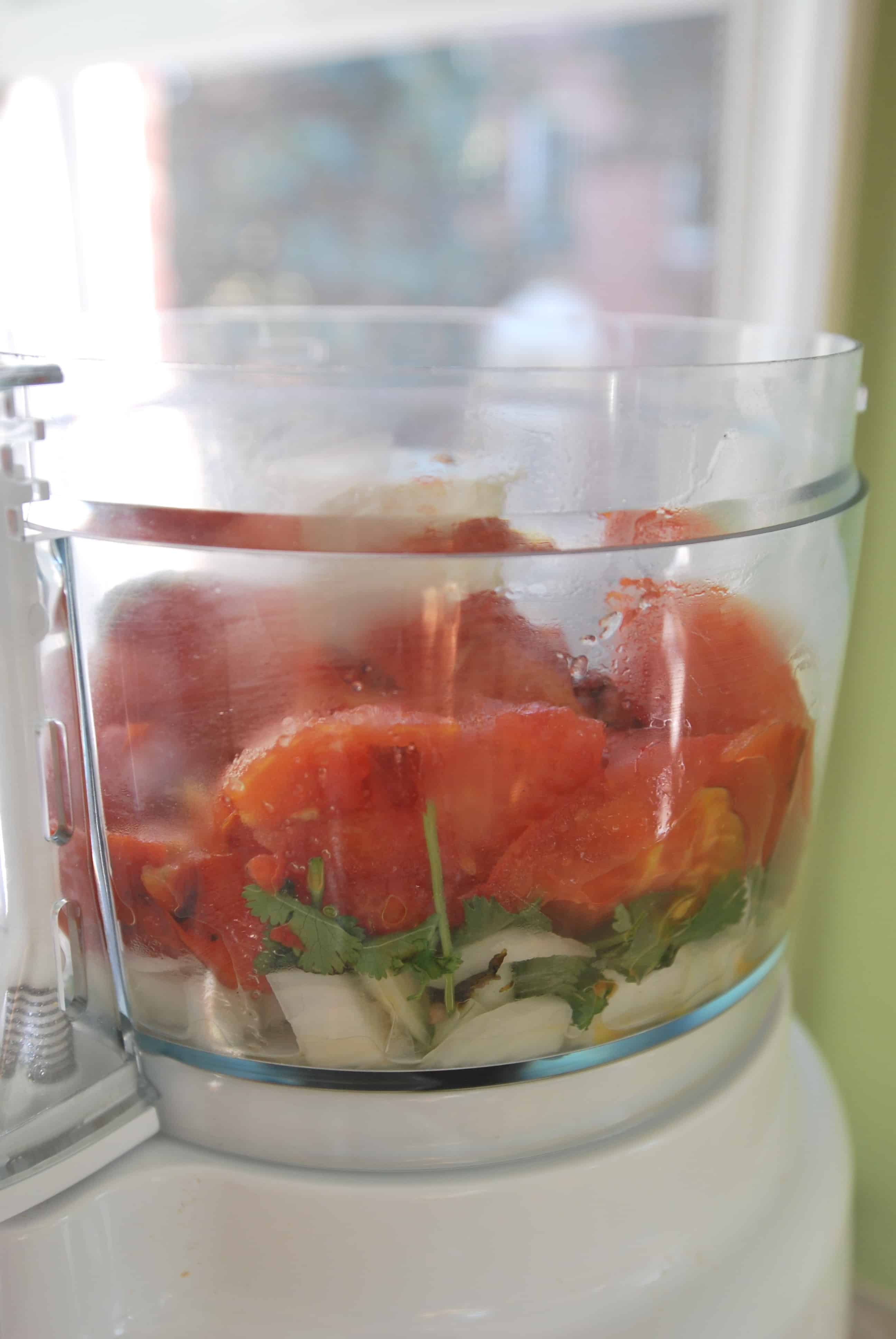 How to Make Roasted Tomato Salsa: roasted tomato salsa being made in a food processor