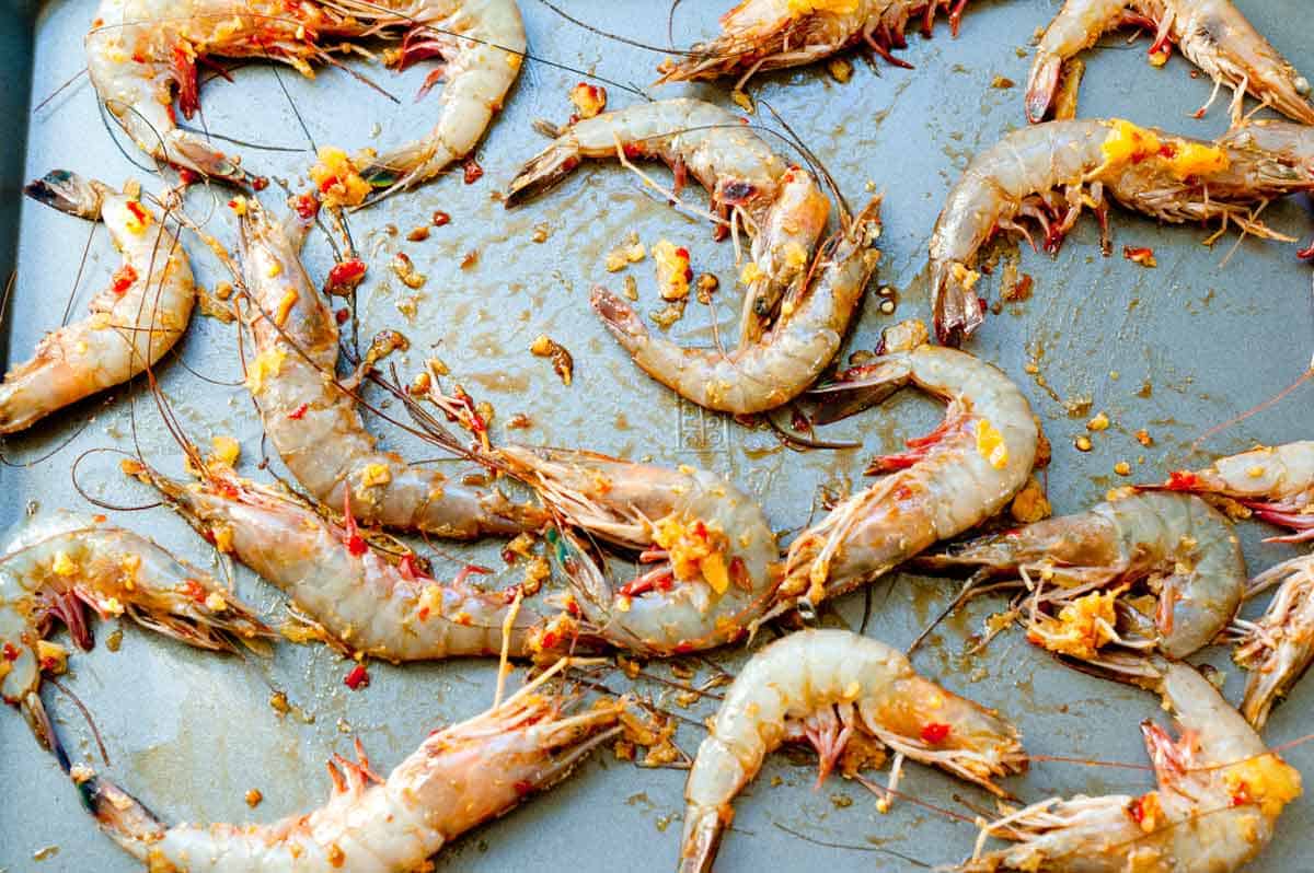 Chili Baked Shrimp Recipe How to Make Chili Butter Head On Shrimp: shrimp on a baking sheet.