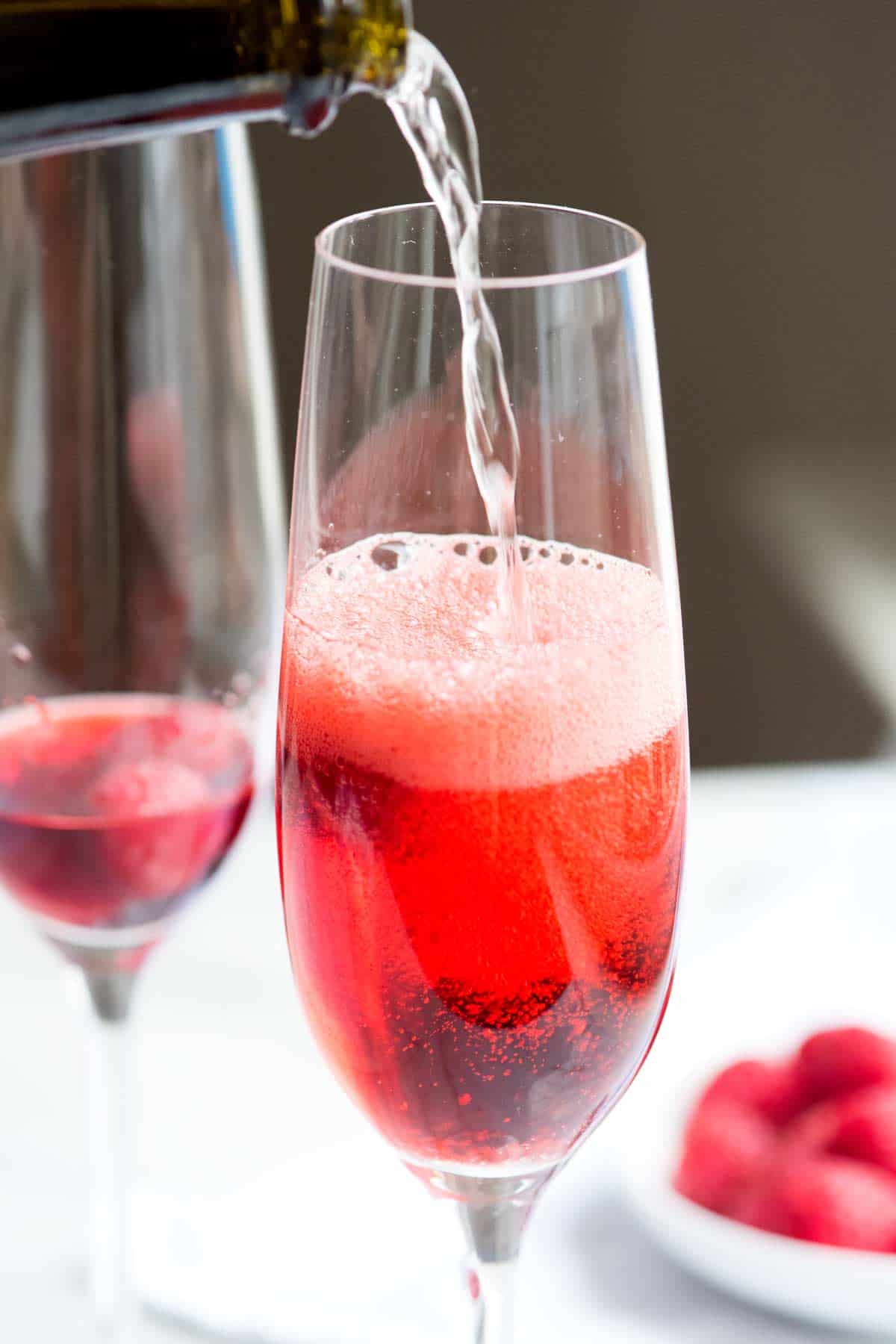 Perfect Kir Royale Recipe Pouring sparkling wine to make Kir Royale