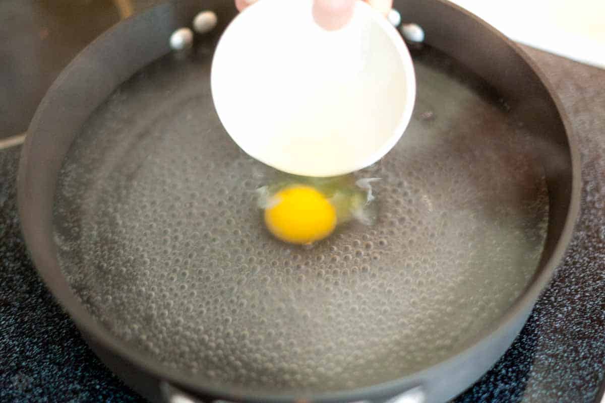 How to Easily Poach an Egg Perfectly Every Time Crack egg into a small bowl then add to poaching water