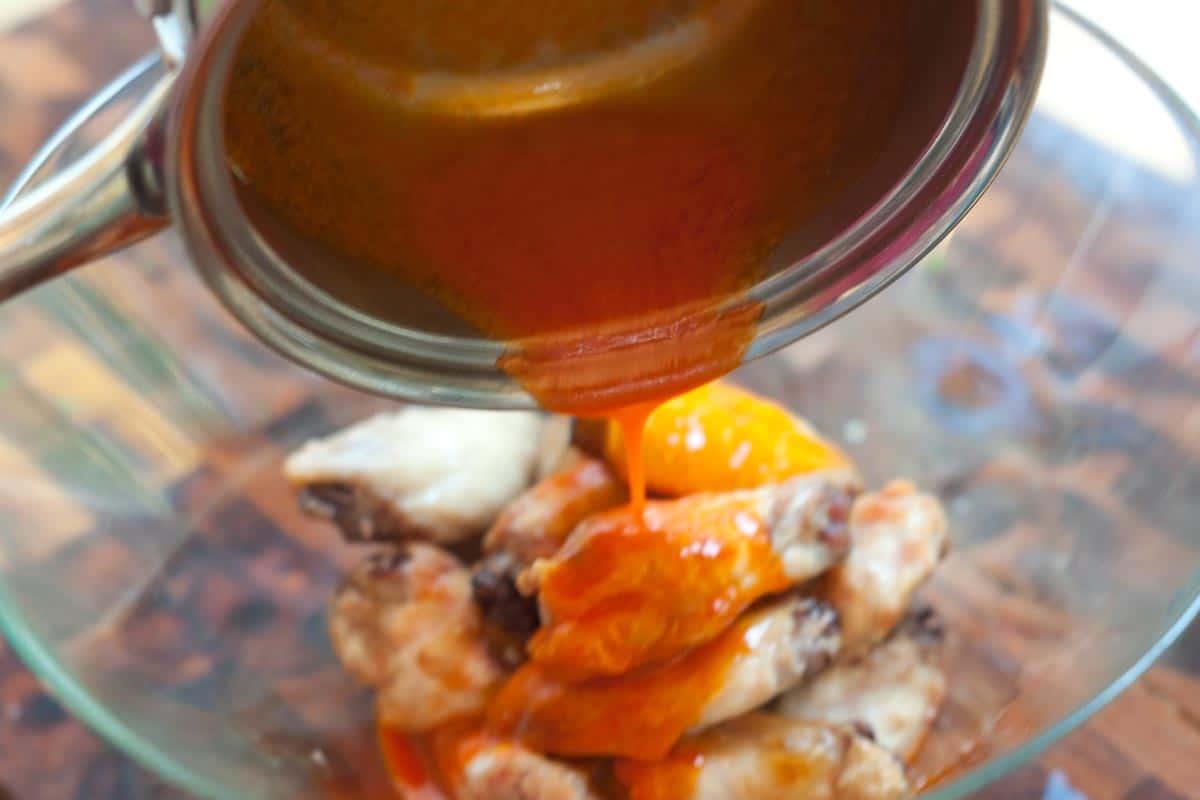 Adding Buffalo sauce to baked chicken wings