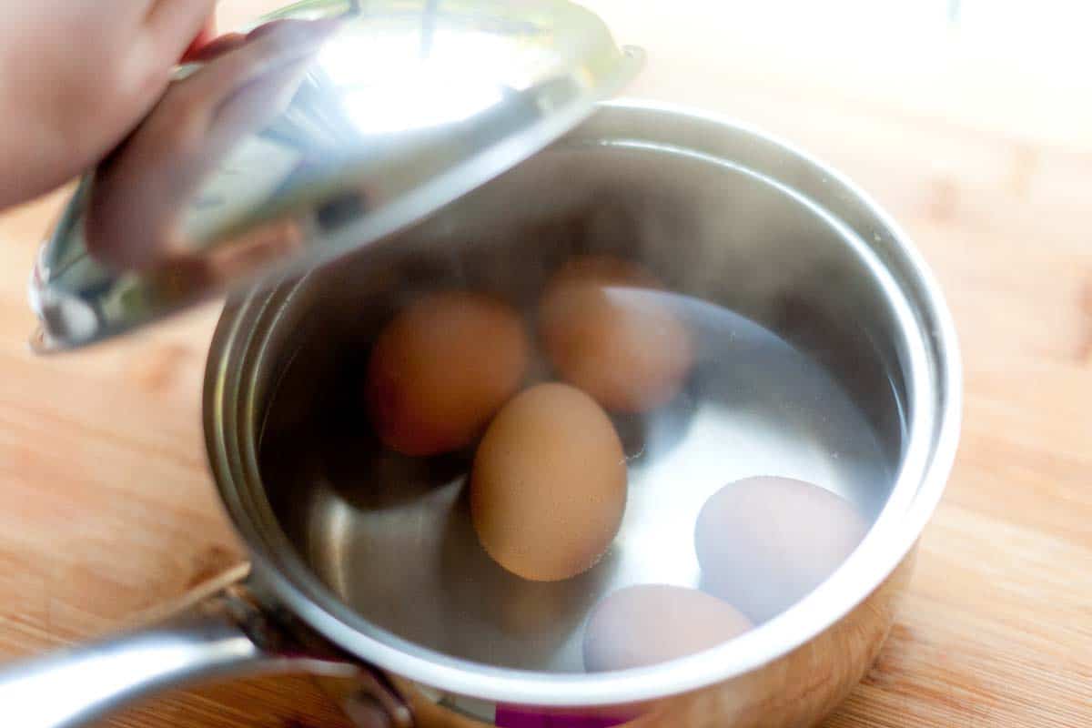 After boiling for 30 seconds, I move the pan off of the heat, and then set a timer for 10 to 12 minutes (depending on how large my eggs are).