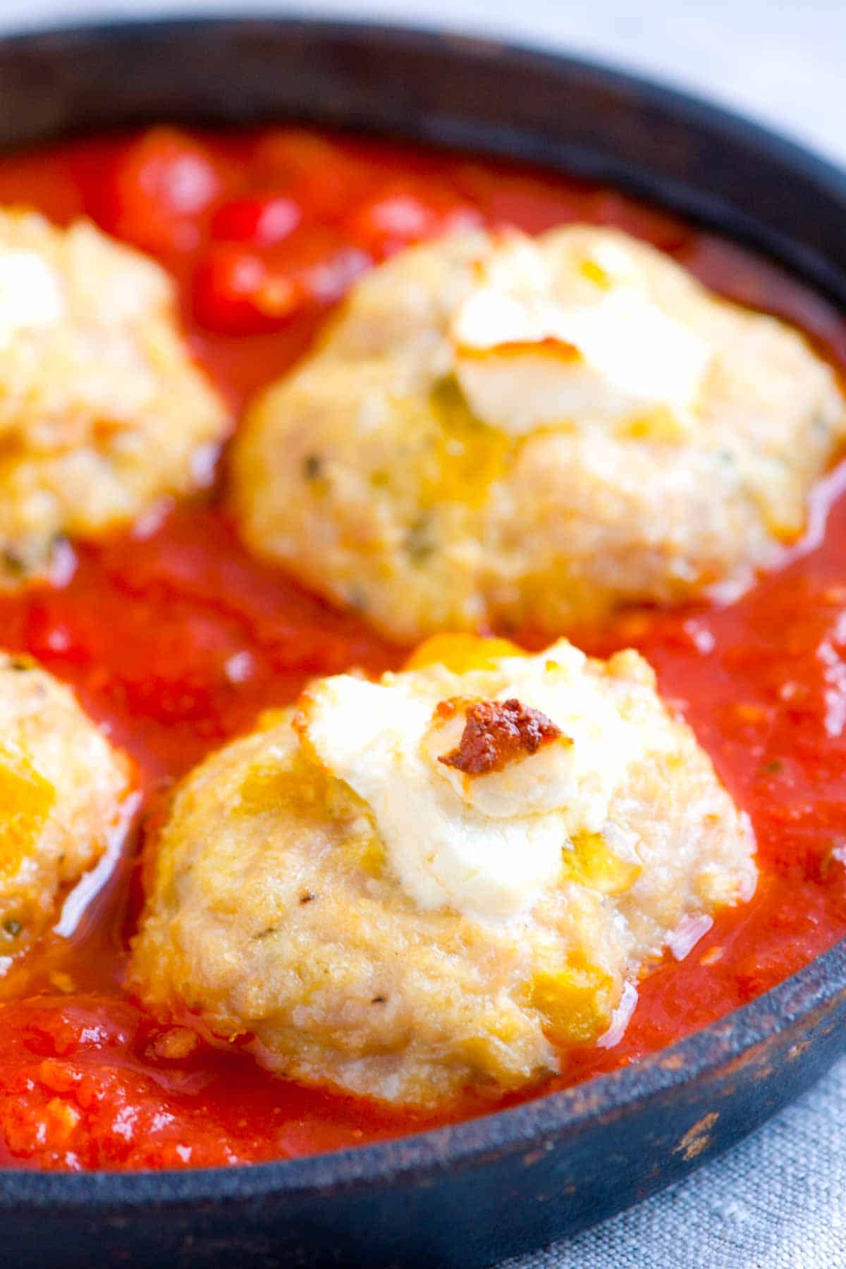 Goat Cheese Stuffed Baked Chicken Meatballs Recipe Cheese stuffed chicken meatballs on a bed of marinara sauce