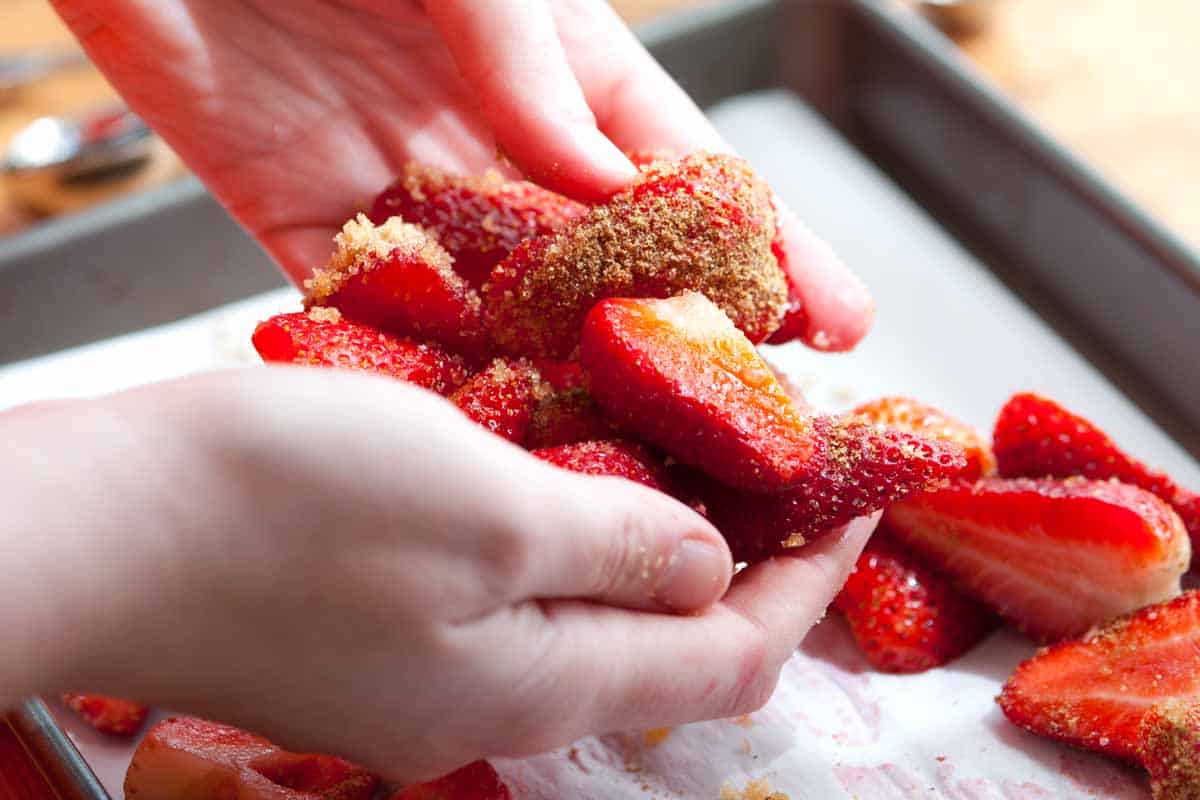 How to Roast Strawberries How to Make Roasted Strawberries: Tossing fresh strawberries with brown sugar and spices