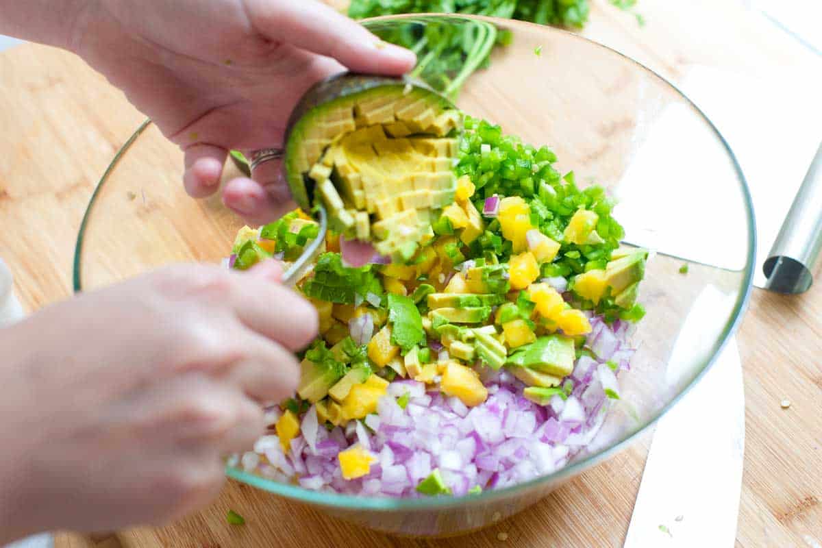 Tossing all salsa ingredients in a large bowl.