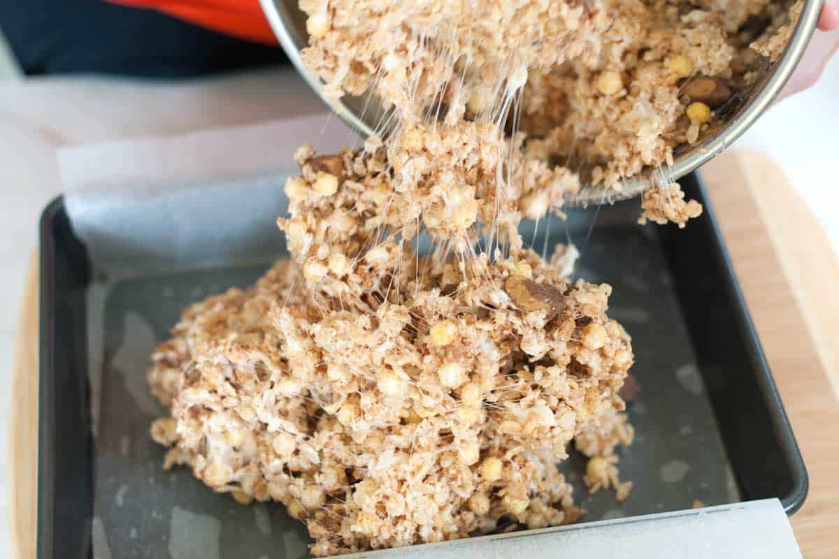 Chocolate Covered Reese's Rice Krispie Treats Adding to the pan