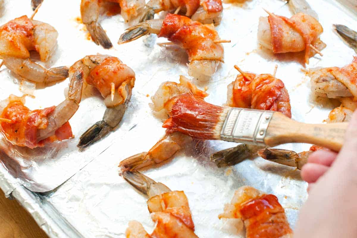 How to Make the Best Bacon Wrapped Shrimp Brushing the spicy maple glaze on to the bacon wrapped shrimp before baking in the oven