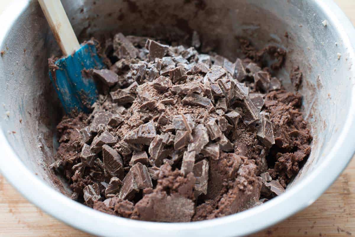 How to Make Chewy Double Chocolate Cookies Folding chopped chocolate into chocolate cookie dough.