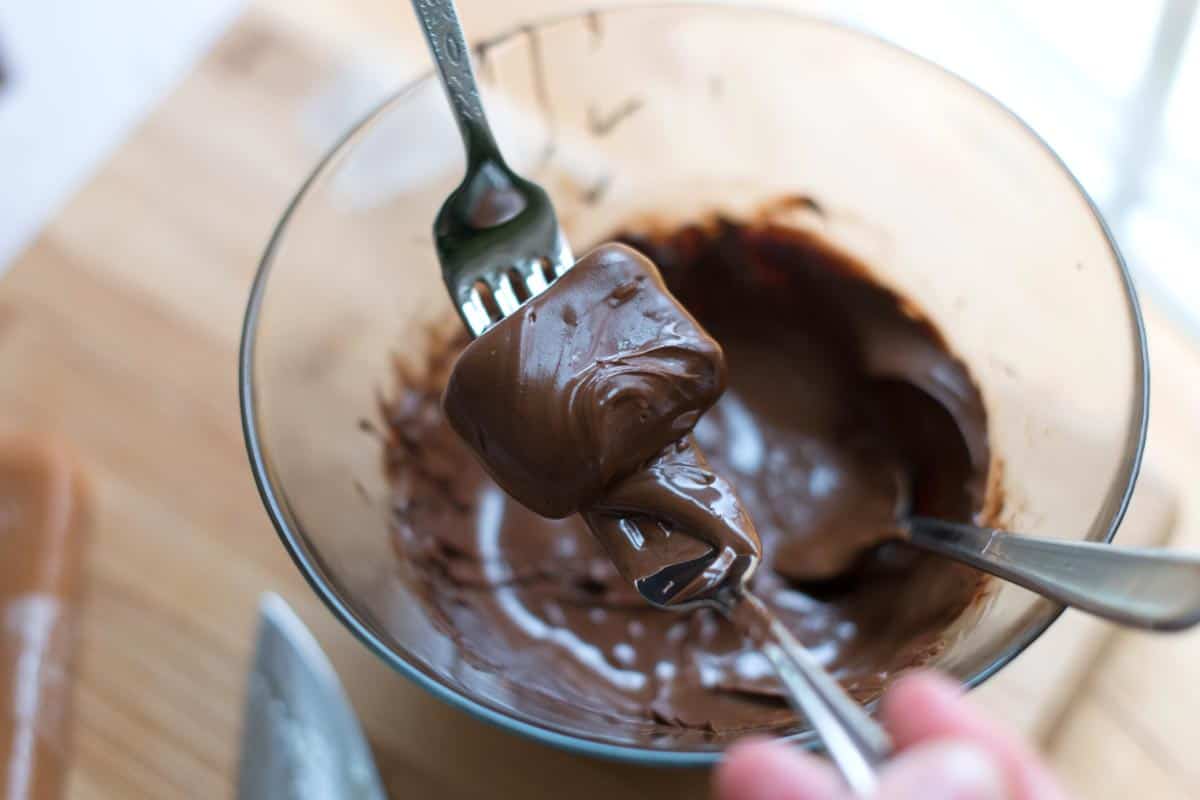 Dunking Caramels into Chocolate for Chocolate Covered Caramels
