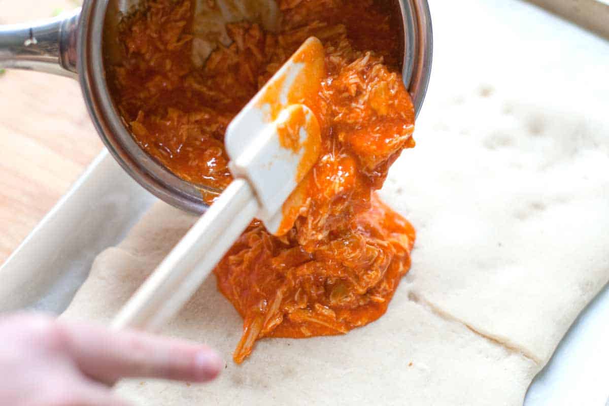 How to Make Crazy Good Buffalo Chicken Pizza Sticks Adding the buffalo chicken to the pizza crust