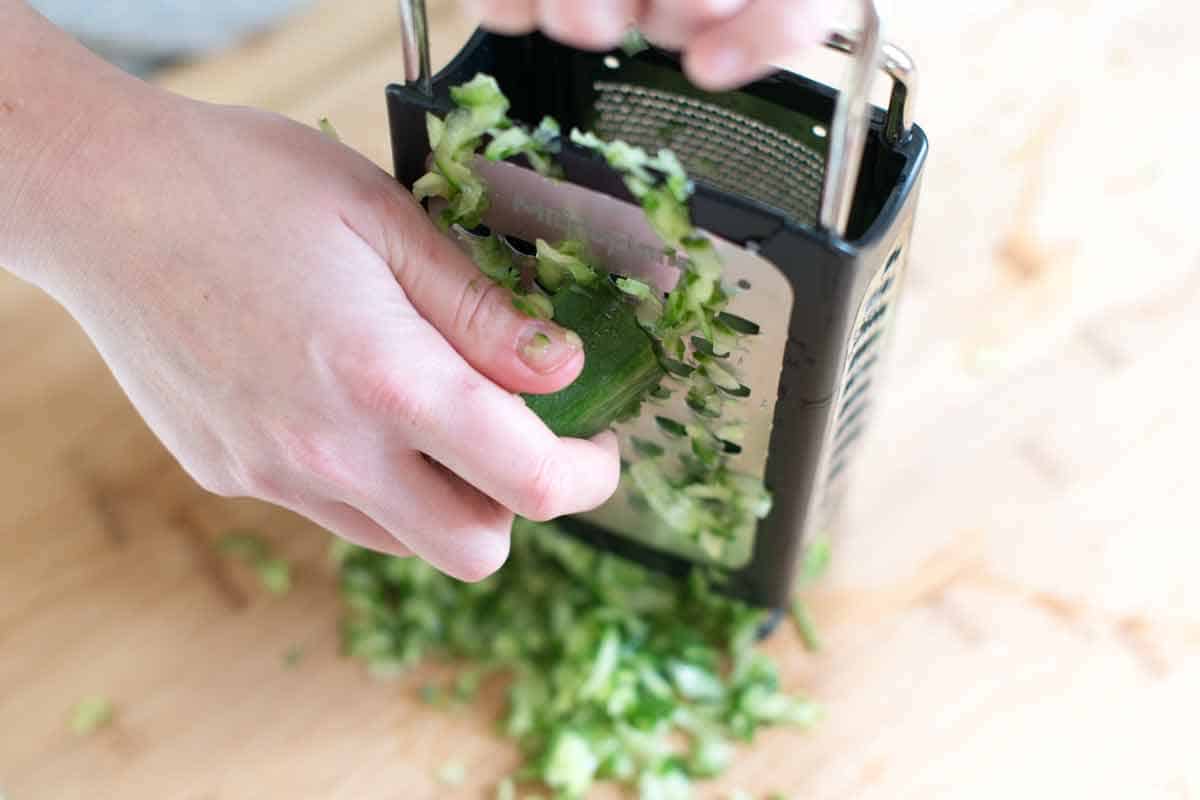 How to Make Feta Tzatziki: Grating cucumbers