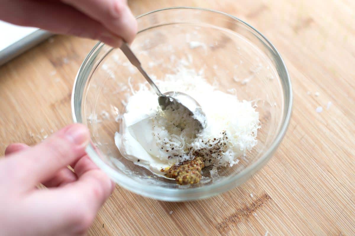 Making the sour cream topping for the salmon in a small bowl