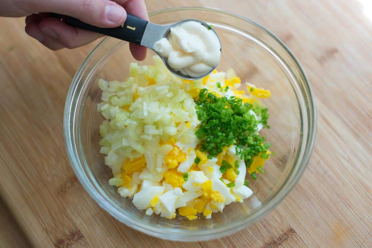 Making egg salad - ingredients ready to be stirred together in a bowl