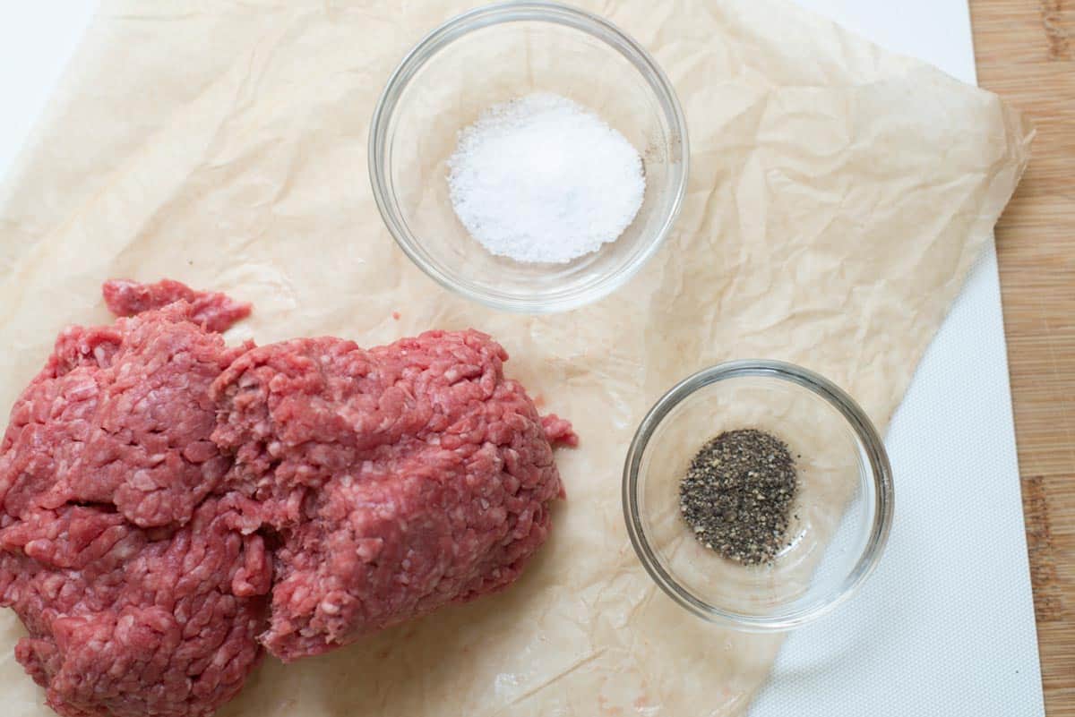 Ground meat, salt and pepper ready for the best burgers.