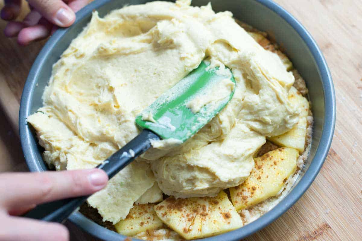 Use Fresh Pineapple for the Best Upside Down Pineapple Cake Spreading the cake batter over the pineapple.