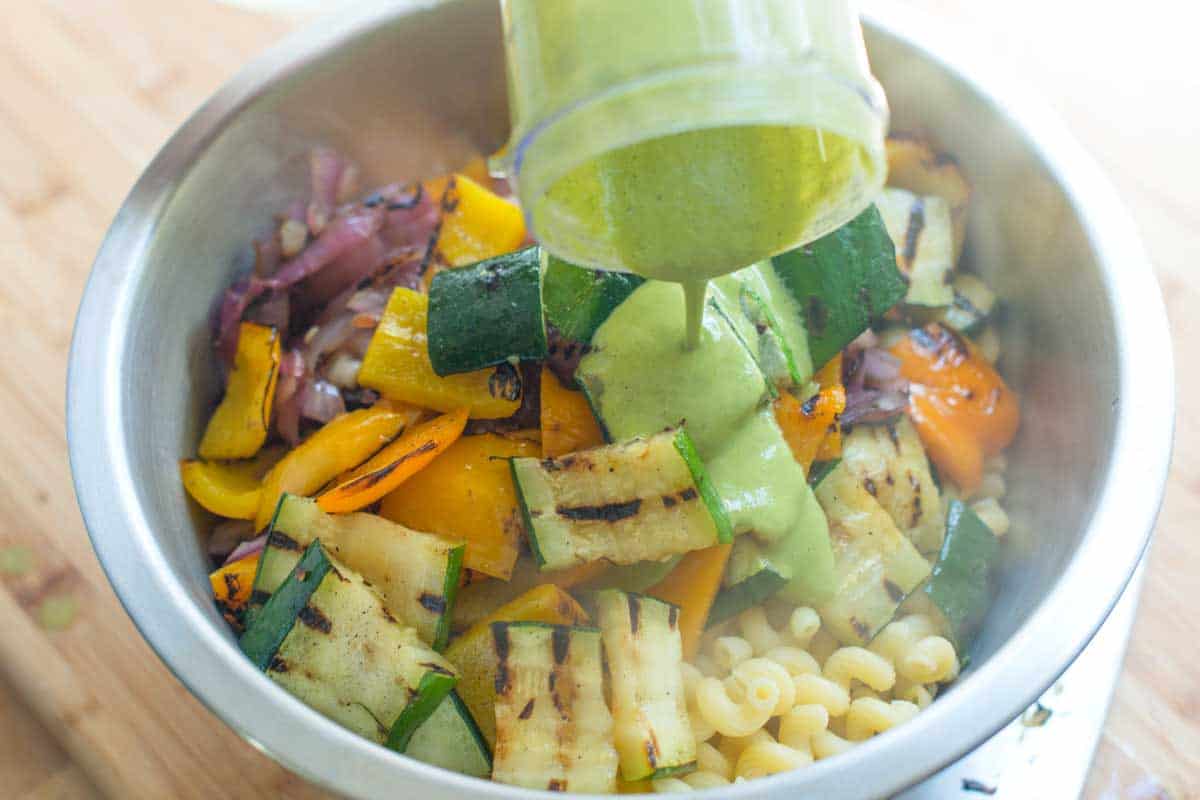 Lemon Basil Pasta Salad Recipe with Veggies Adding the lemon basil dressing to pasta and grilled vegetables