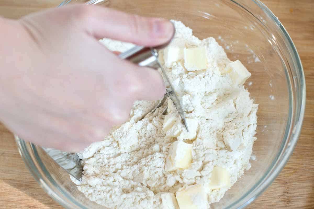 Cranberry Scones Recipe Cutting cold butter into flour