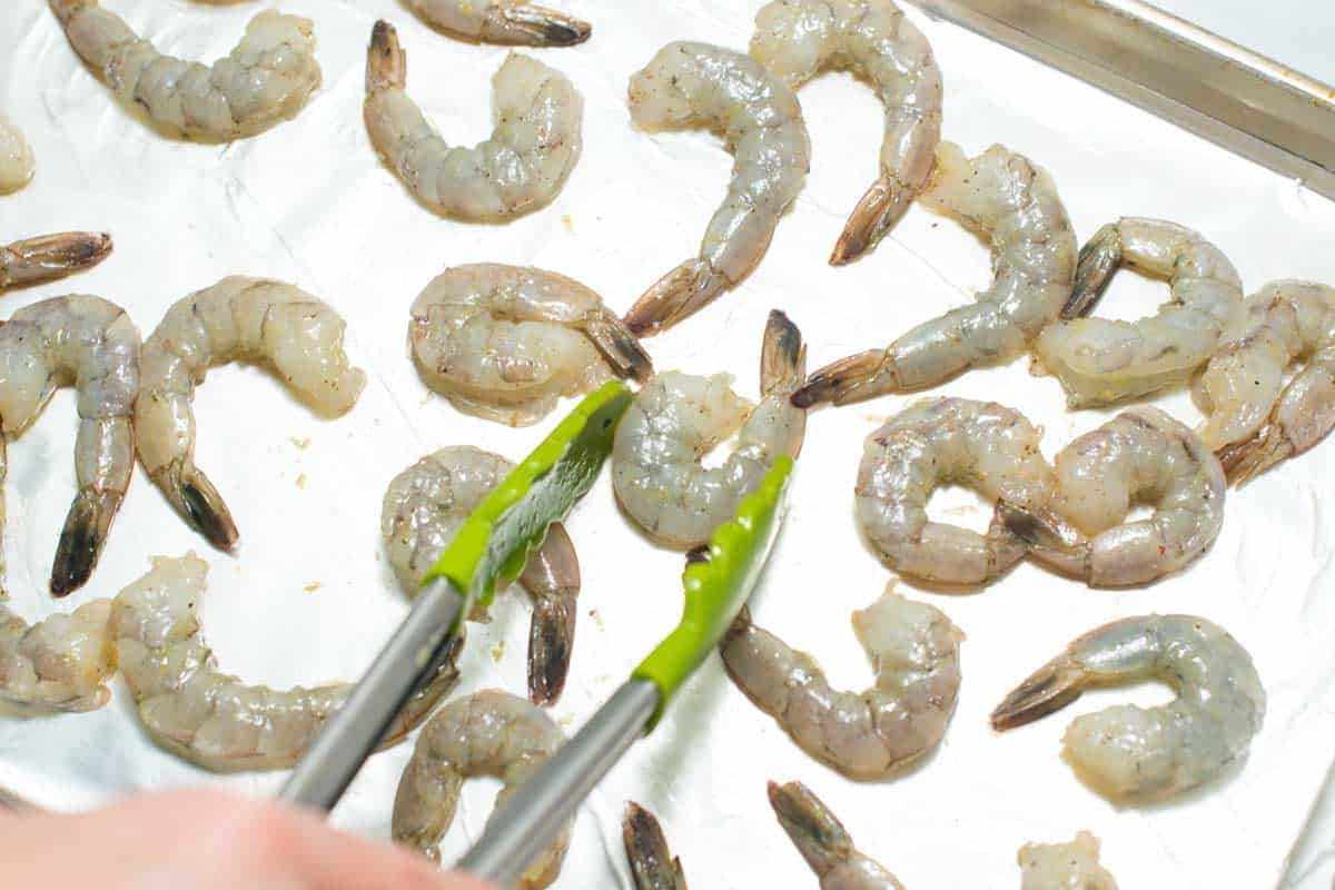 Shrimp on baking sheet to make shrimp cocktail