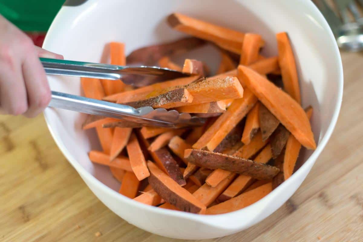 Seasoning sweet potato fries before baking them