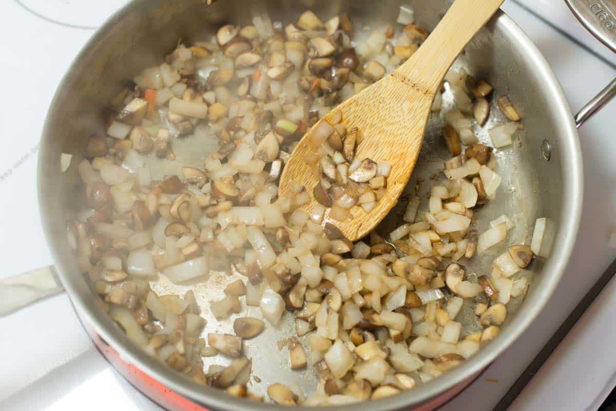 Cooking mushrooms and onions for the spinach mushroom lasagna filling