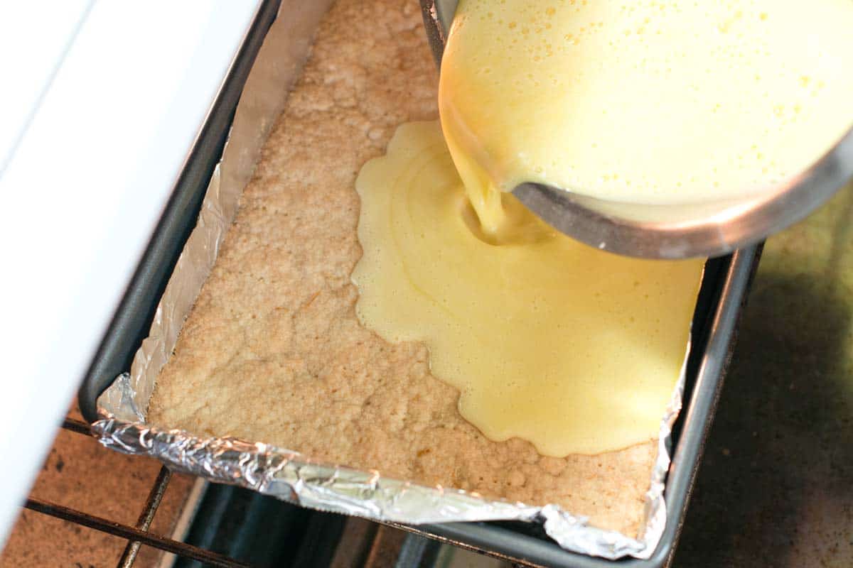 Pouring the lemon filling over a prebaked crust