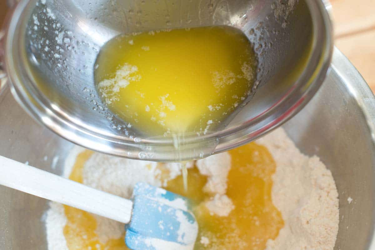 Pouring melted butter into flour for the lemon bar crust