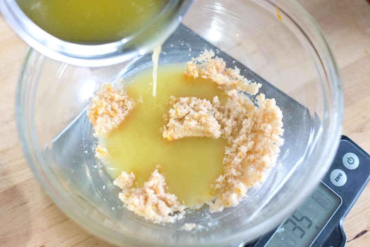 Adding melted butter while it’s warm to flour for our shortbread cookie dough