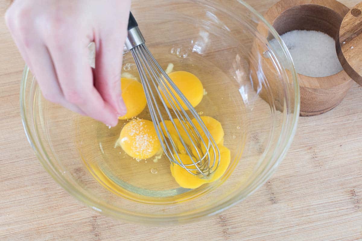 Whisking eggs with salt for the best scrambled eggs