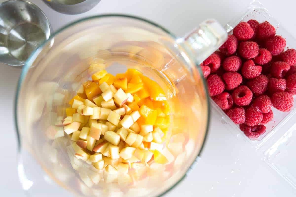 Muddling apples and peaches for white sangria