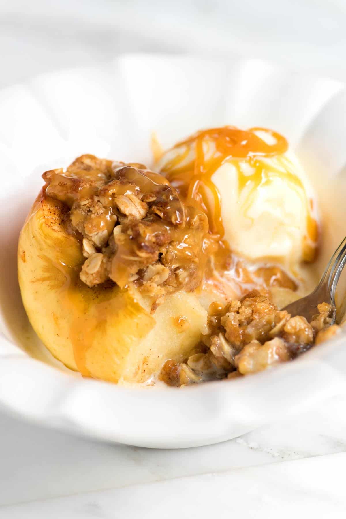 Serving baked apples with ice cream and caramel sauce