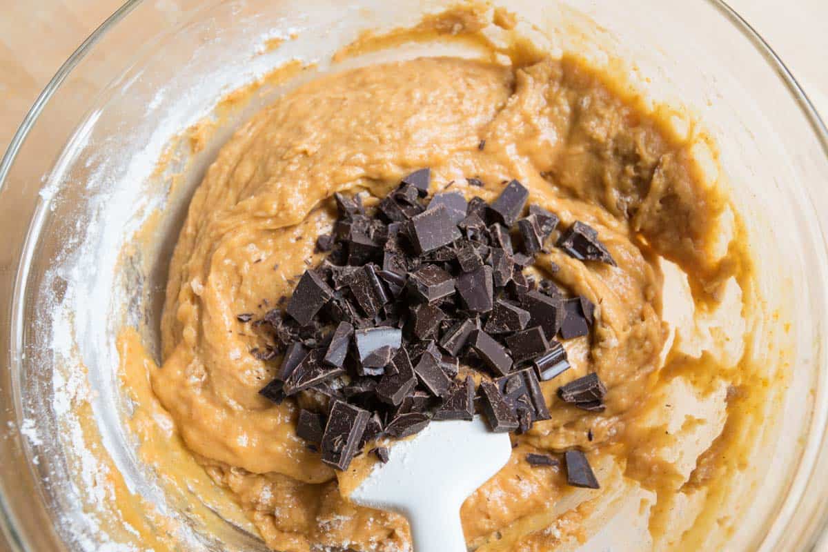 Adding the chocolate chips to the pumpkin bread batter