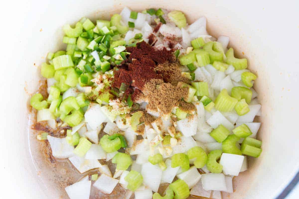 Cooking the veggies and spices in chicken fat.