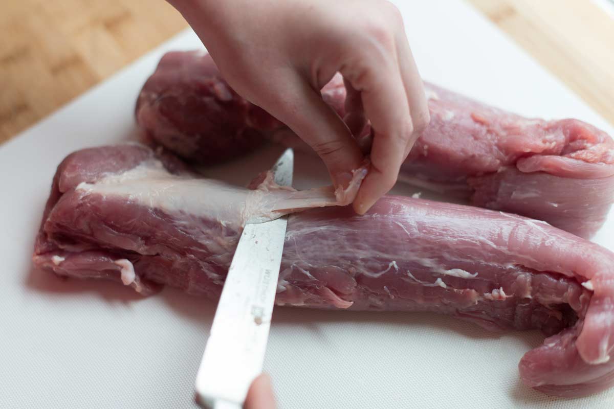 Removing tougher silver skin from pork tenderloins before cooking them