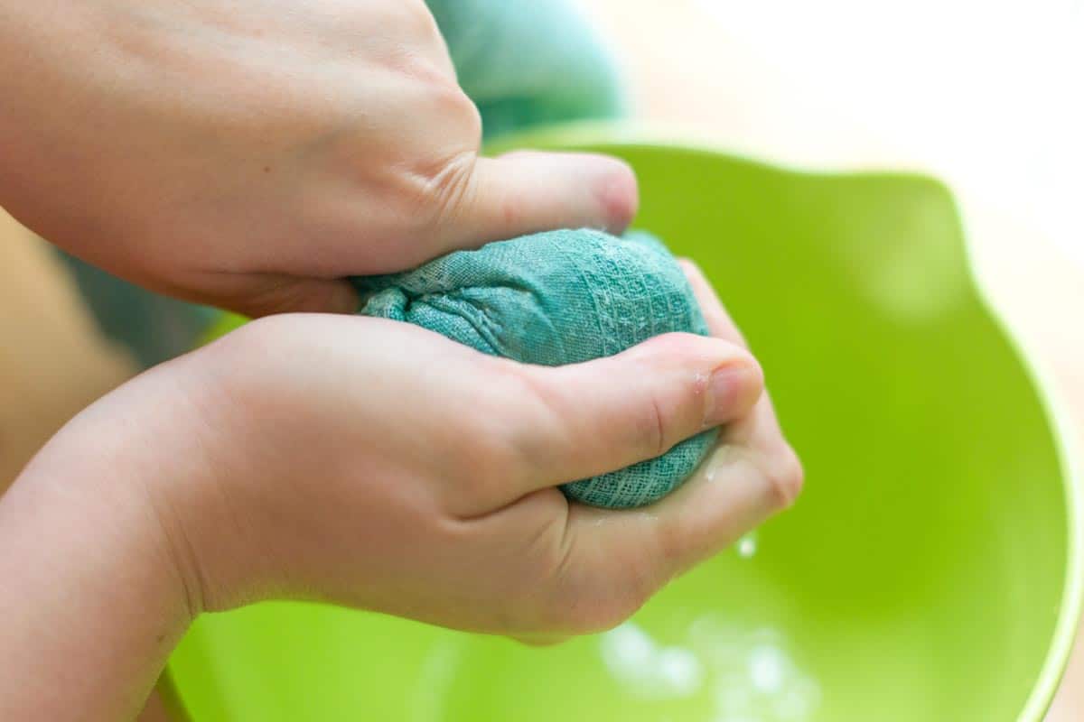 Squeezing out water of cucumbers.