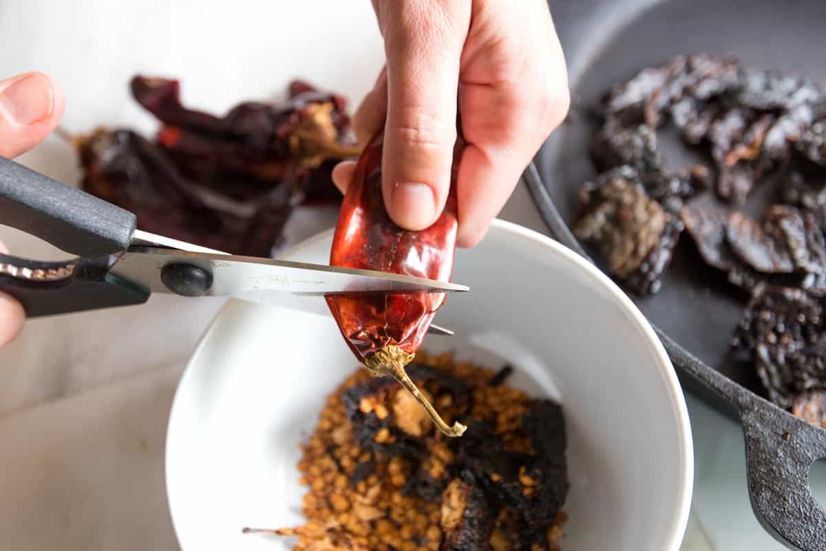 There's three simple steps for preparing the dried chiles Cutting the stems off dried chili peppers