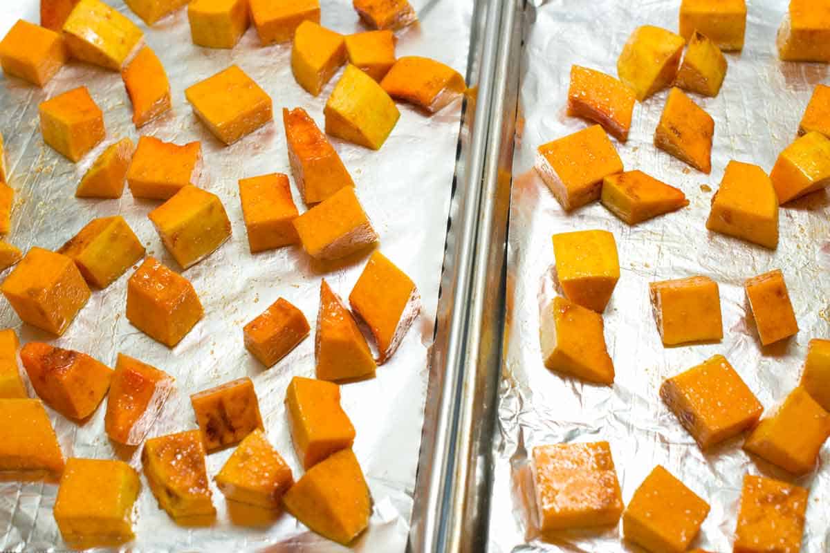 Butternut squash cubes on baking sheets.