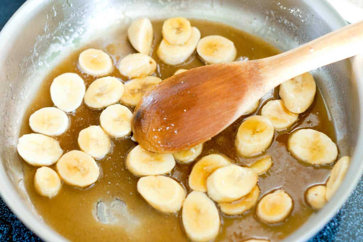 Bananas cooking in caramel sauce for banana shortcake