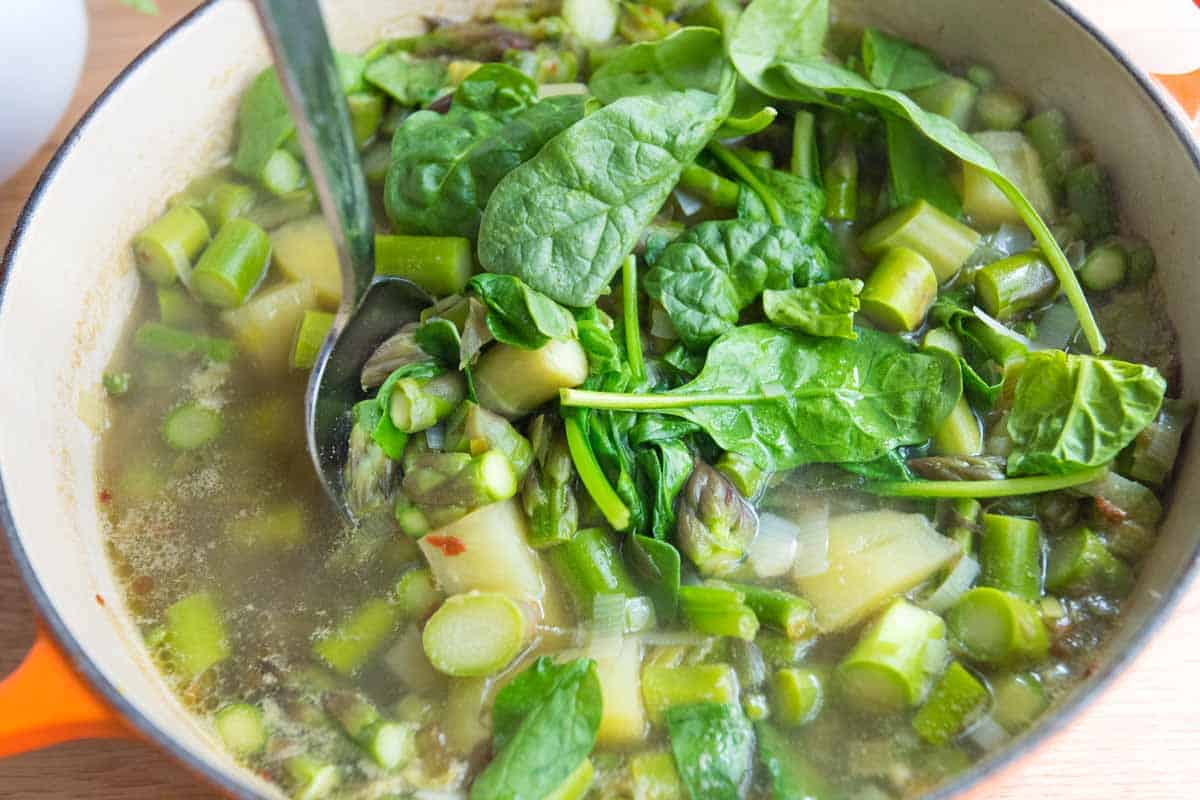 Finishing with fresh spinach to make the soup more green.