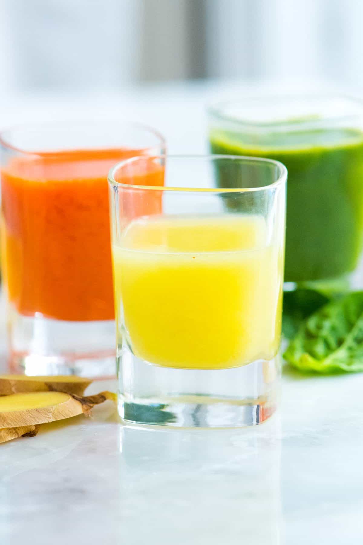 Three Ginger Power Shot Recipes including Lemon Ginger, Carrot Ginger and a Green Apple Ginger Shot Ginger Shots