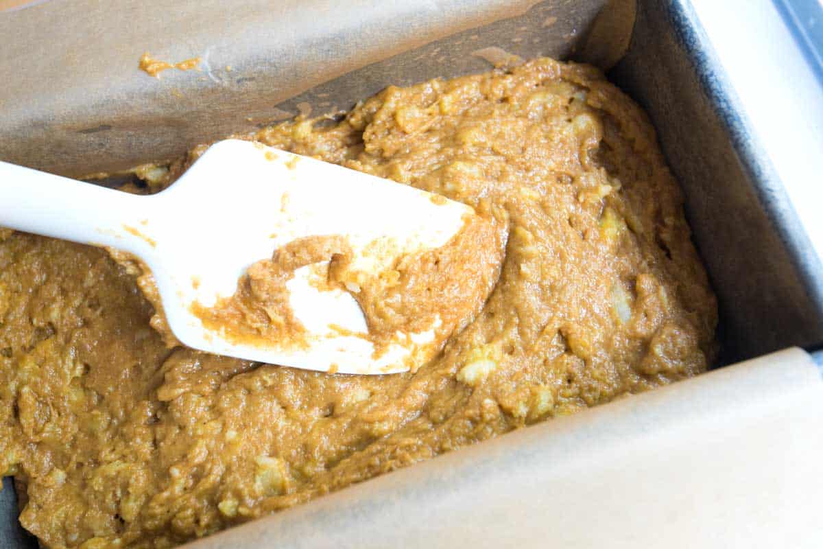 Spreading banana bread batter in a loaf pan