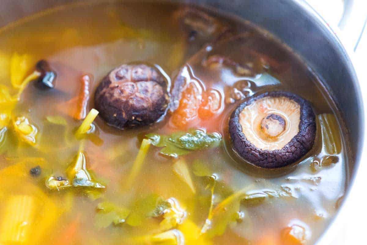 Adding dried mushrooms to make homemade vegetable broth
