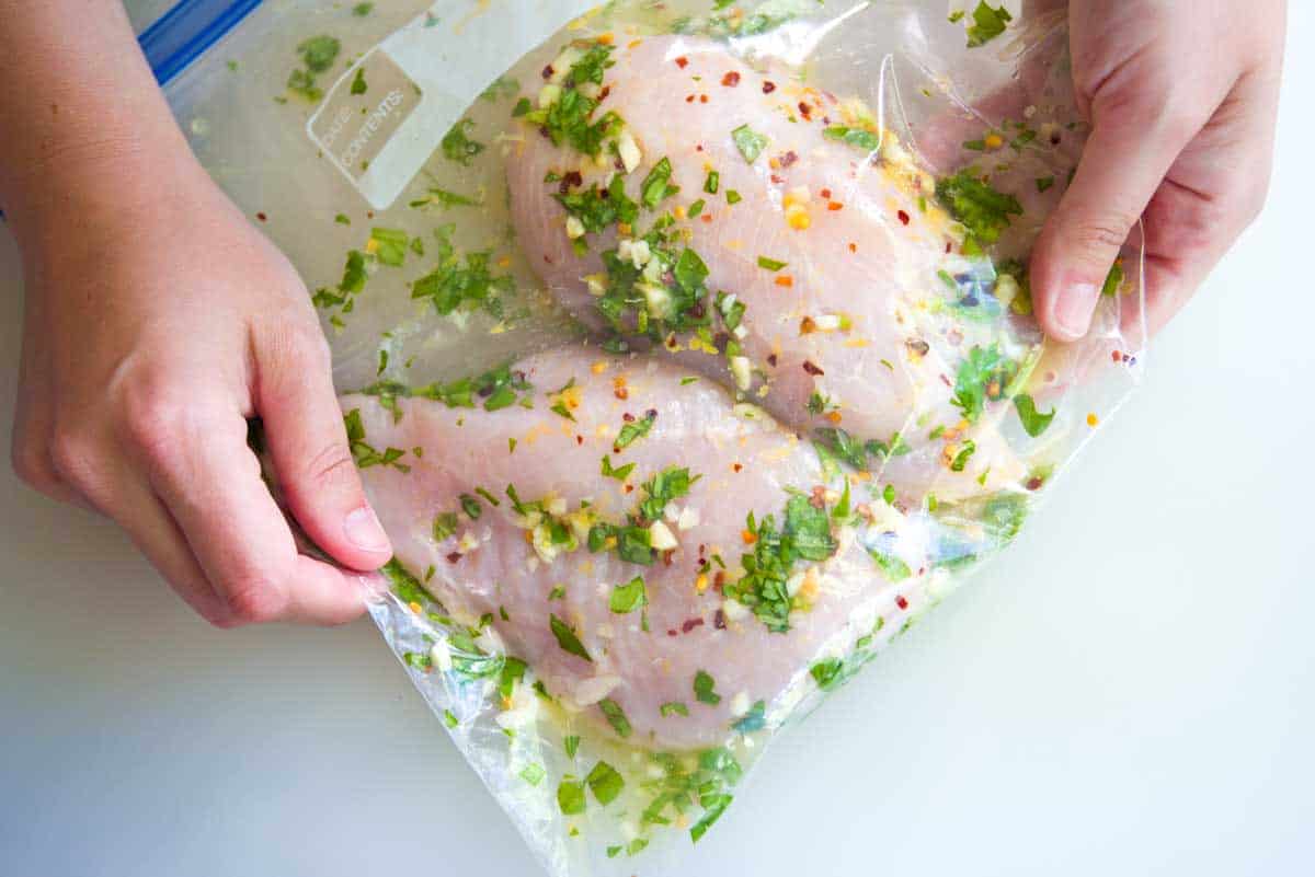 Marinating the chicken breasts for chicken caprese salad