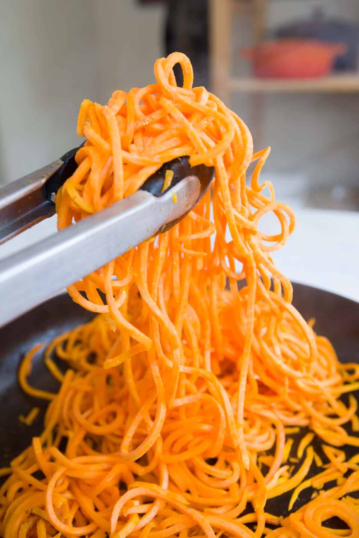 Creamy Avocado Sweet Potato Noodles Recipe Cooking spiralized sweet potato noodles in a skillet