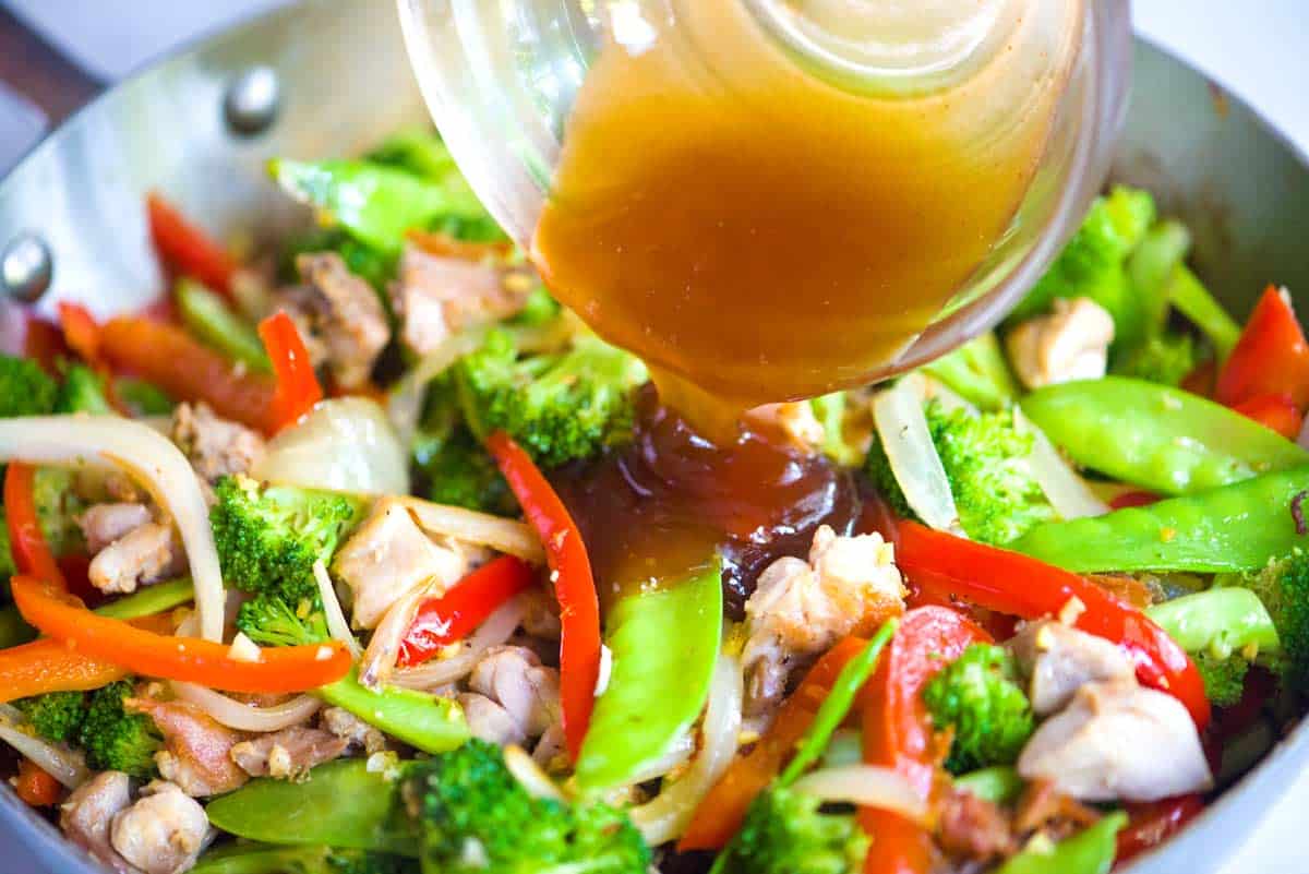 Adding the homemade stir fry sauce to the skillet