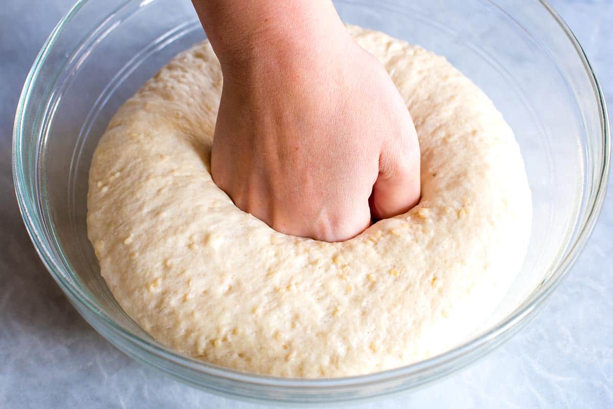 Punching down the flatbread dough