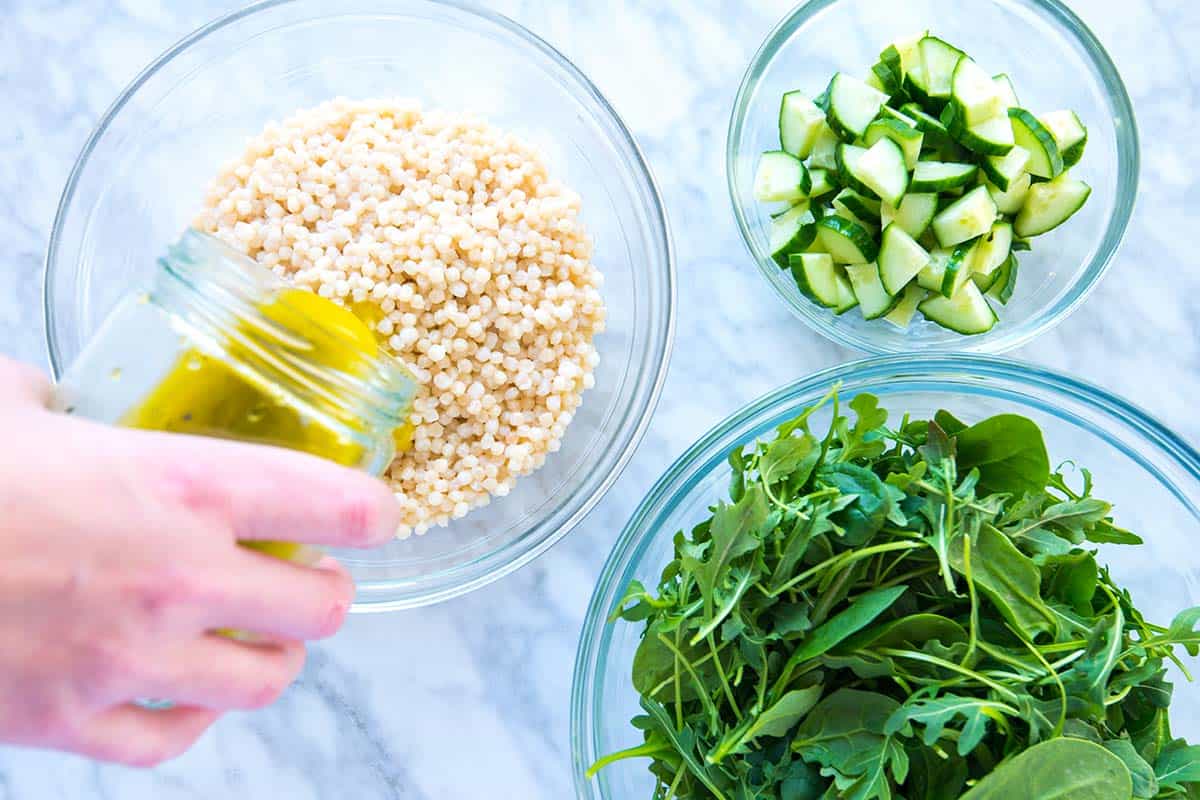 How to Make Arugula Couscous Salad: Adding lemon vinaigrette to couscous for the salad