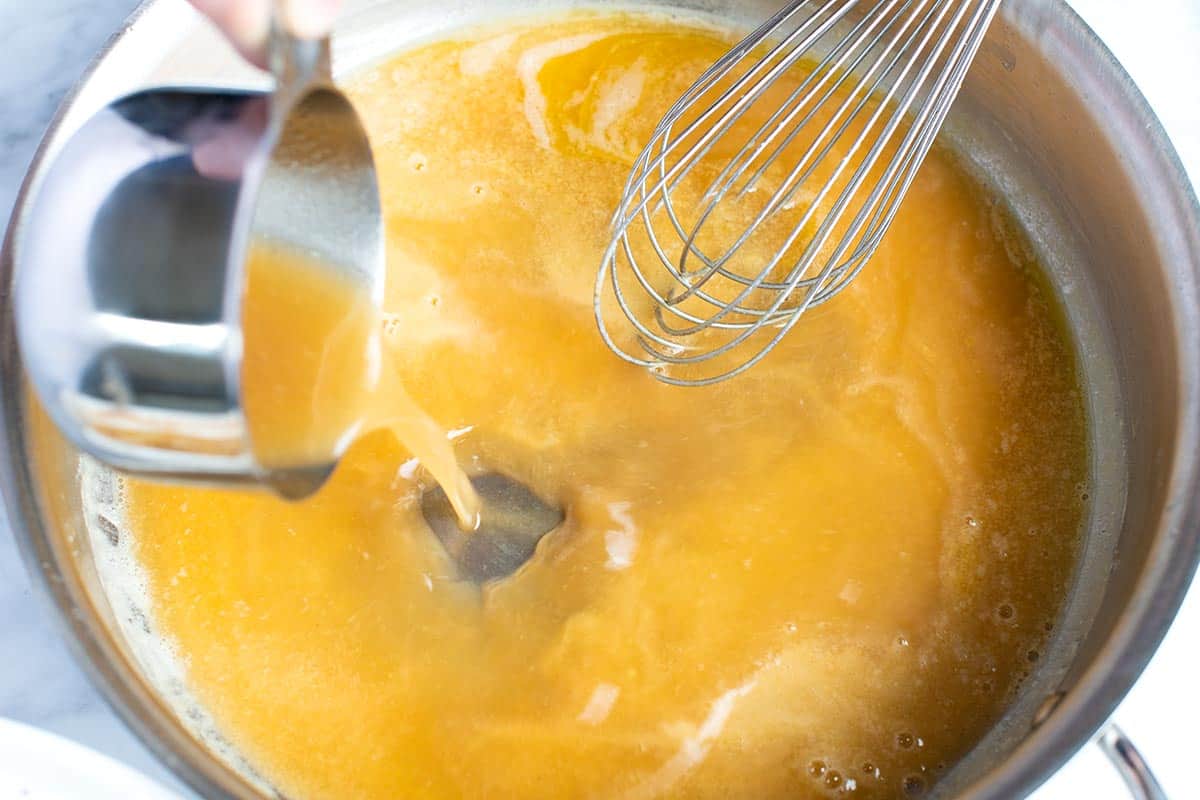 Adding warm stock to a roux made from melted butter and flour too make homemade gravy