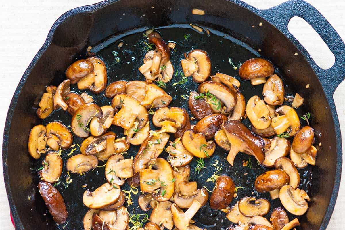 Mushrooms cooking in skillet.