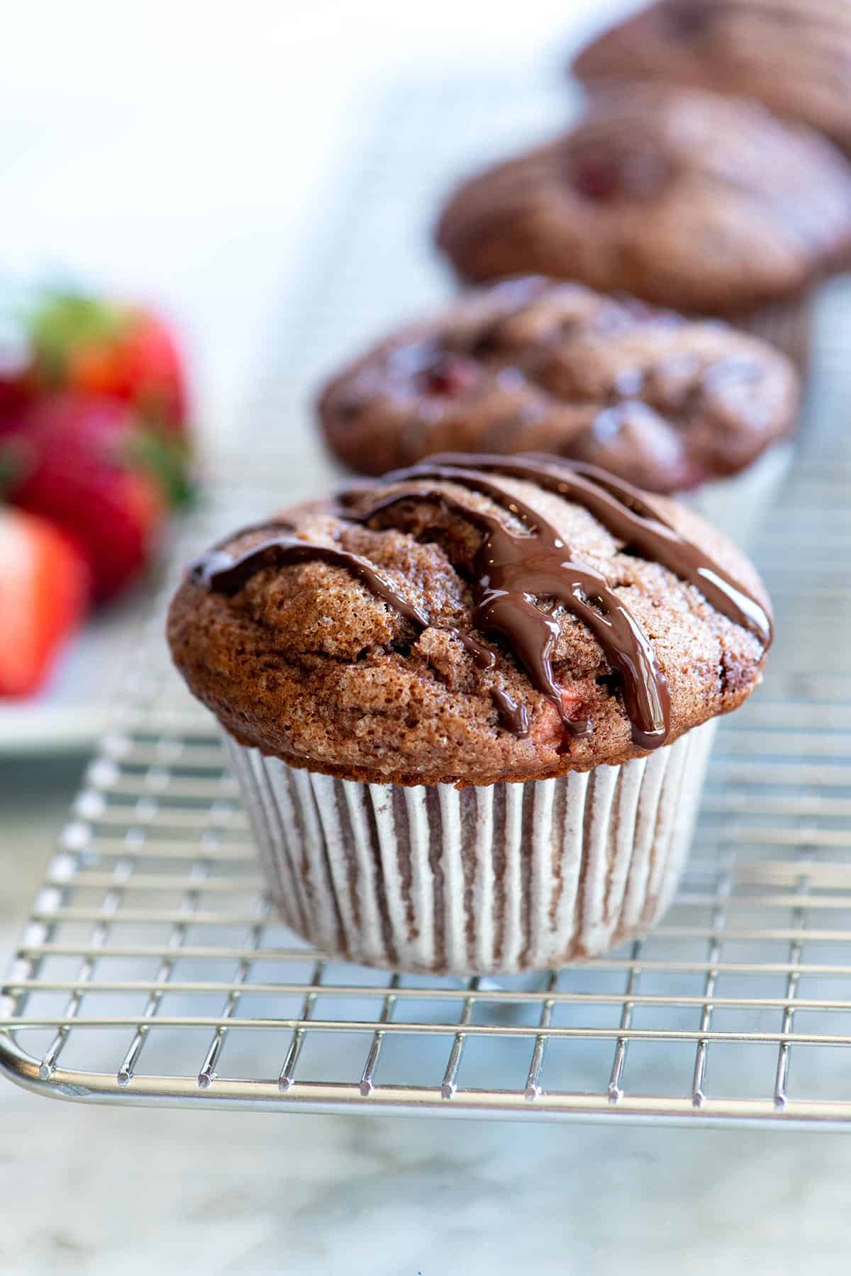 This easy chocolate muffins recipe combines two of our favorite things: fresh strawberries and chocolate! See how to make tender muffins packed with strawberries and topped with a chocolate drizzle. Chocolate Strawberry Muffins