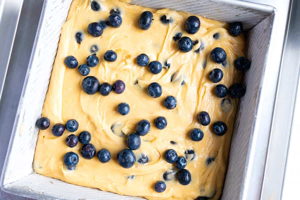 Adding cake batter to baking pan